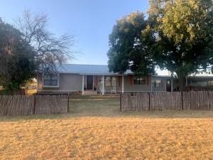 2232 Private Road 4032 Road Eden, TX 76837 - Photo 18 of 40 a view of a backyard with large tree and wooden fence
