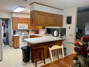 a kitchen with a sink refrigerator and cabinets