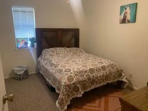 a bed sitting in a bedroom next to a window