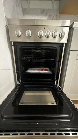 a view of a room with wooden floor and cabinets