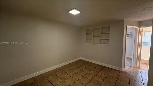 an empty room with a ceiling fan and a fan