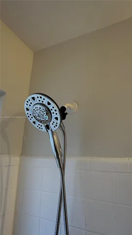 a backyard of a house with table and chairs with wooden fence