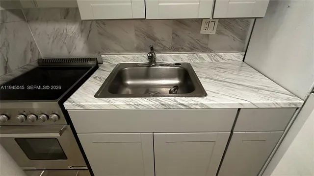 a kitchen with a stove and a refrigerator