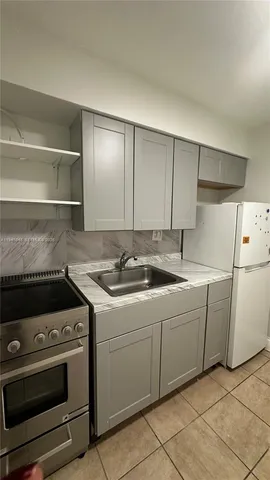 a kitchen with a stove and a sink