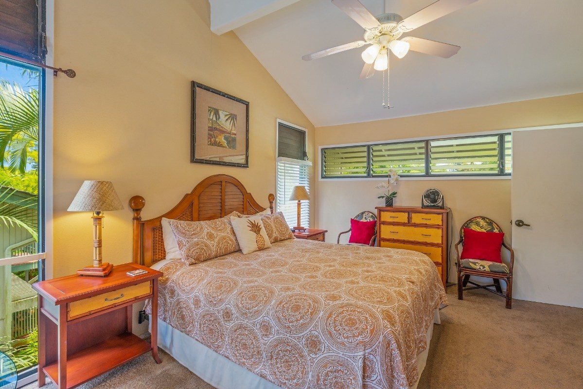 5301 Ka Haku Road, Unit 208 Princeville, HI 96722 - Photo 11 of 27 a bedroom with a bed and a chandelier