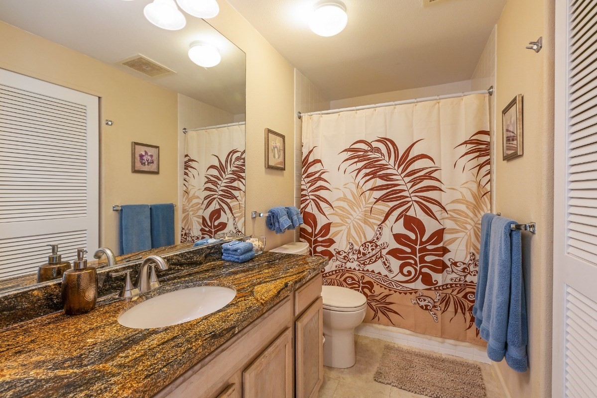 5301 Ka Haku Road, Unit 208 Princeville, HI 96722 - Photo 13 of 27 a bathroom with a granite countertop sink and a mirror