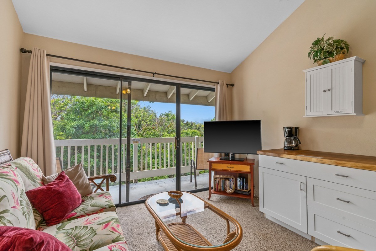 5301 Ka Haku Road, Unit 208 Princeville, HI 96722 - Photo 19 of 27 a living room with furniture and a flat screen tv
