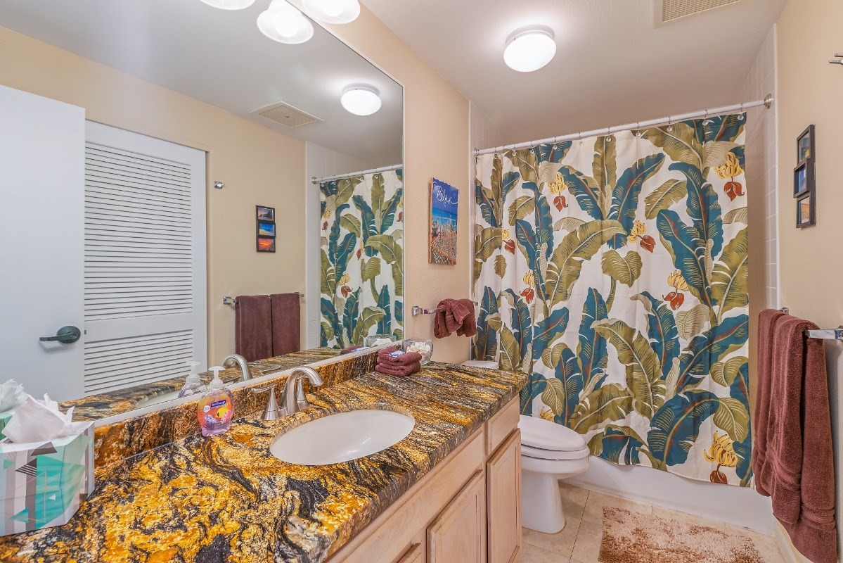 5301 Ka Haku Road, Unit 208 Princeville, HI 96722 - Photo 27 of 27 a bathroom with a granite countertop sink and a mirror