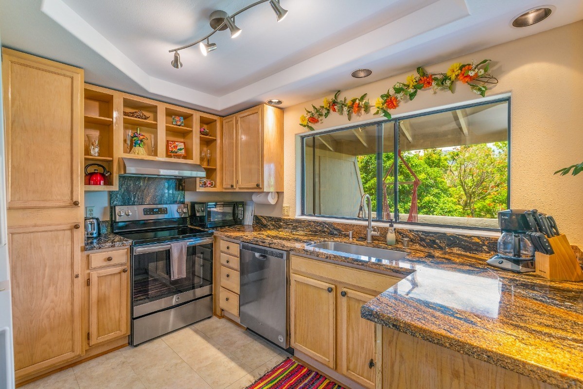 5301 Ka Haku Road, Unit 208 Princeville, HI 96722 - Photo 7 of 27 a kitchen with a stove a sink and a refrigerator