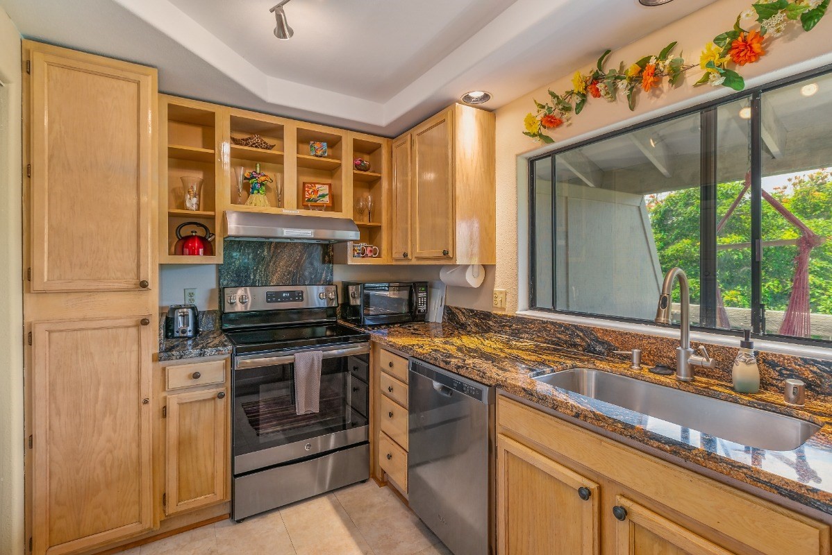 5301 Ka Haku Road, Unit 208 Princeville, HI 96722 - Photo 8 of 27 a kitchen with stainless steel appliances granite countertop a stove and a sink