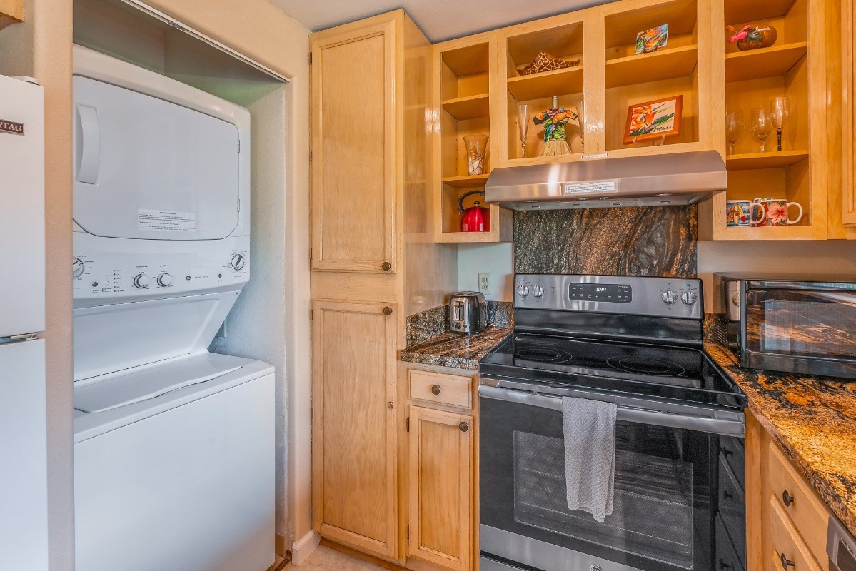5301 Ka Haku Road, Unit 208 Princeville, HI 96722 - Photo 9 of 27 a kitchen with a stove and a microwave
