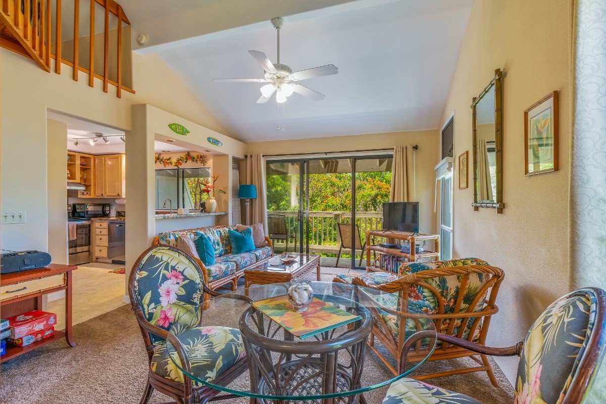 5301 Ka Haku Road, Unit 208 Princeville, HI 96722 - Photo 10 of 27 a dining room with furniture a livingroom view and a floor to ceiling window