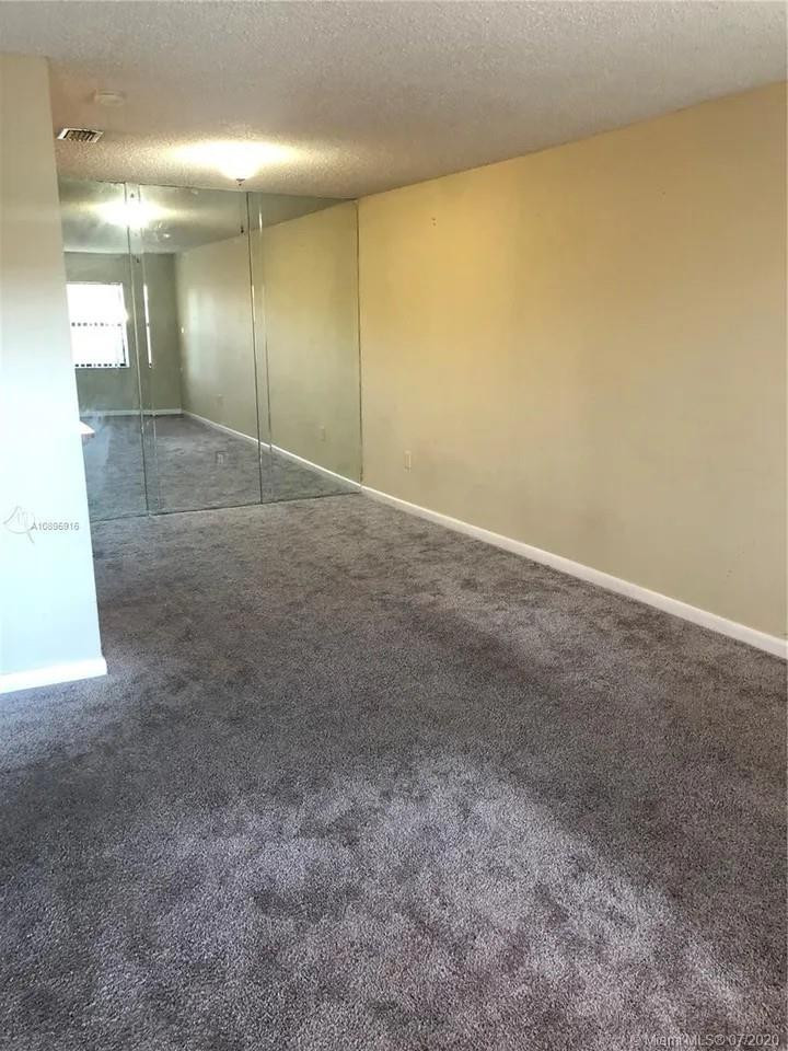 Undisclosed Address Hialeah, FL 33015 - Photo 3 of 7 an empty room with a bathroom