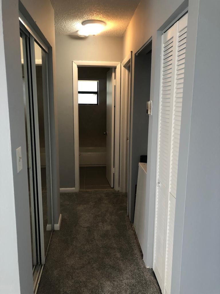 Undisclosed Address Hialeah, FL 33015 - Photo 6 of 7 a view of a hallway with wooden shelves