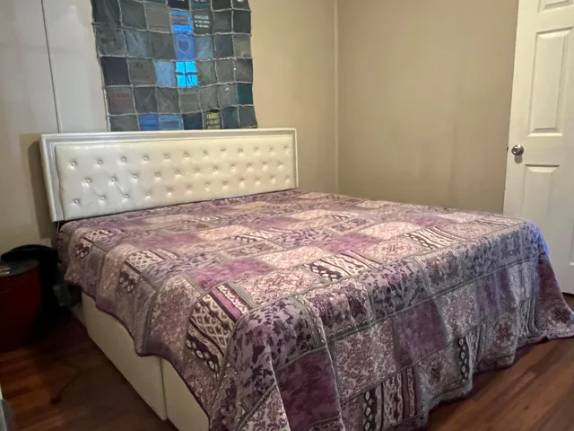 a bed sitting in a bedroom next to a window