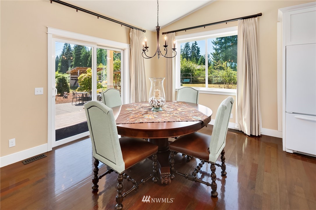 4726 166th Place Southeast Bothell, WA 98012 - Photo 14 of 34 a view of a dining room with furniture window and wooden floor
