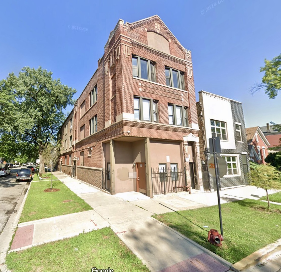 3008 West 23rd Street, Unit 2B Chicago, IL 60623 - Photo 1 of 10 a front view of a house with a yard