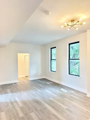 an empty room with windows and closet