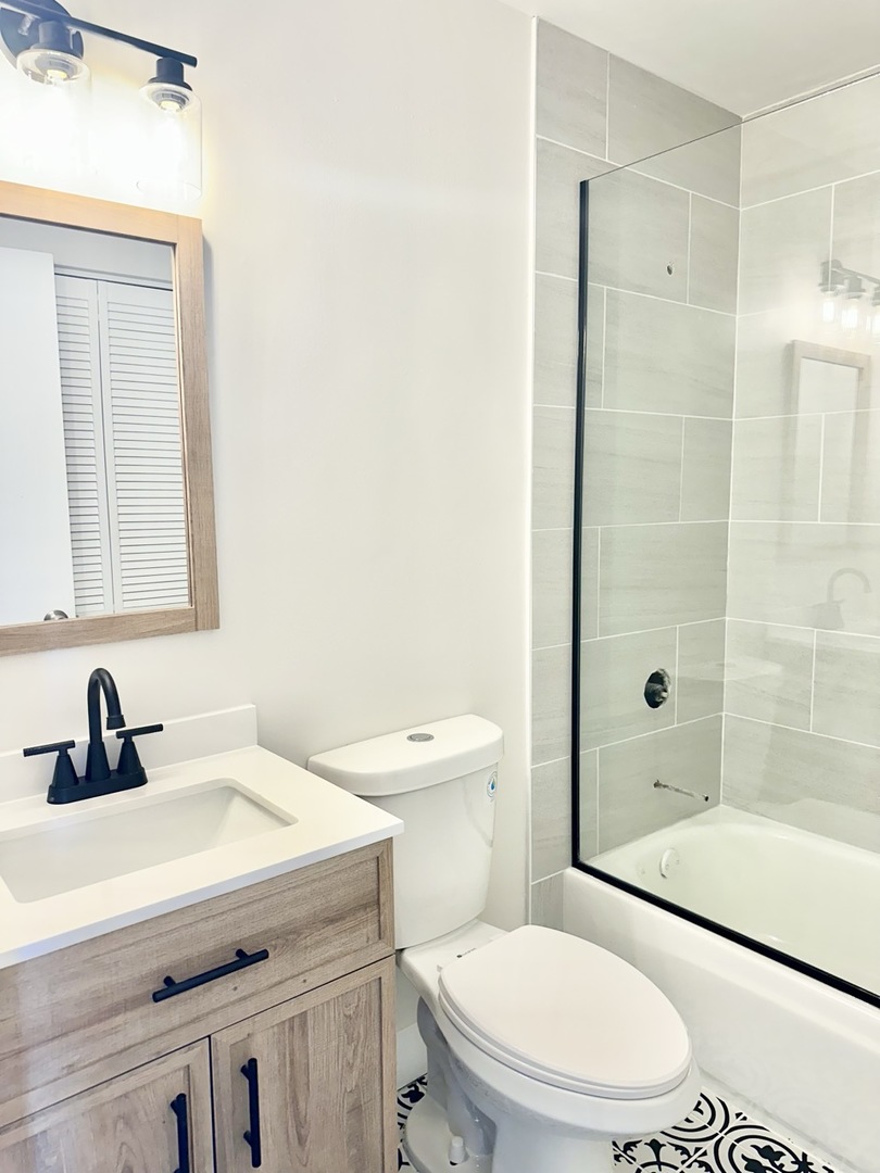 3008 West 23rd Street, Unit 2B Chicago, IL 60623 - Photo 3 of 10 a bathroom with a sink a toilet and shower