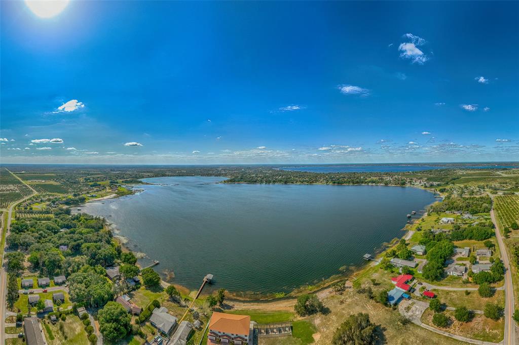 1877 Arbuckle Creek Road Sebring, FL 33870 - Photo 13 of 50 a view of a lake with a house in the background