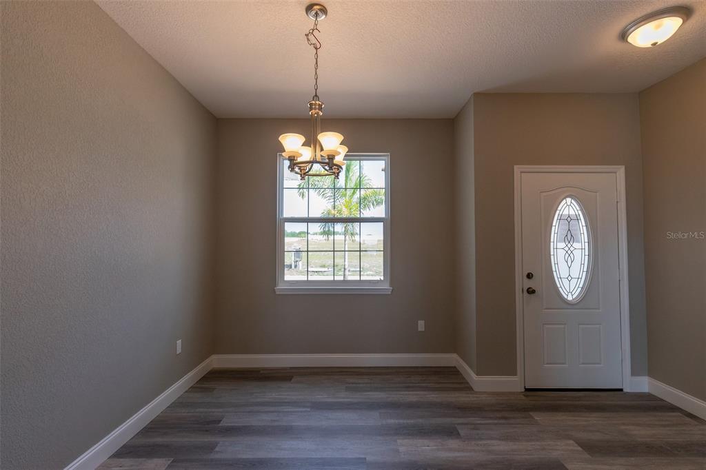 1877 Arbuckle Creek Road Sebring, FL 33870 - Photo 18 of 50 wooden floor in an empty room with a window