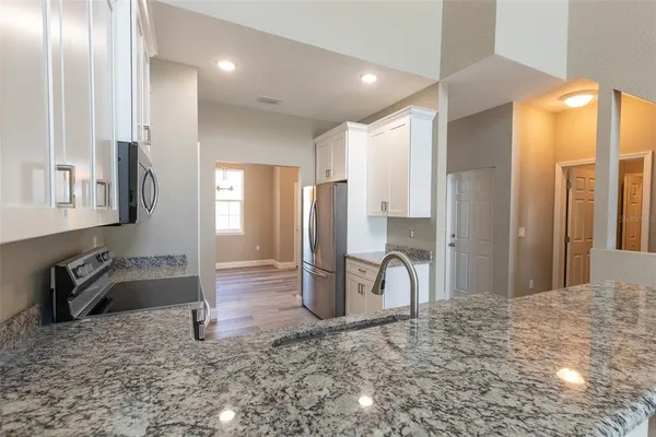 a kitchen with cabinets appliances and a sink
