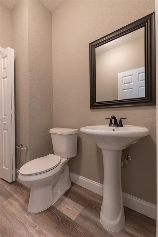 1877 Arbuckle Creek Road Sebring, FL 33870 - Photo 22 of 50 a bathroom with a toilet sink and mirror