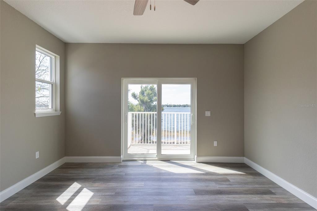 1877 Arbuckle Creek Road Sebring, FL 33870 - Photo 25 of 50 an empty room with wooden floor and windows