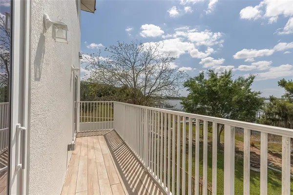 a view of balcony with wooden floor and fence