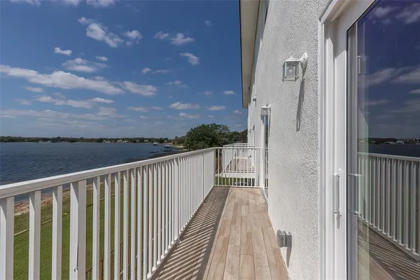 a view of a hallway with wooden floor and cabinet