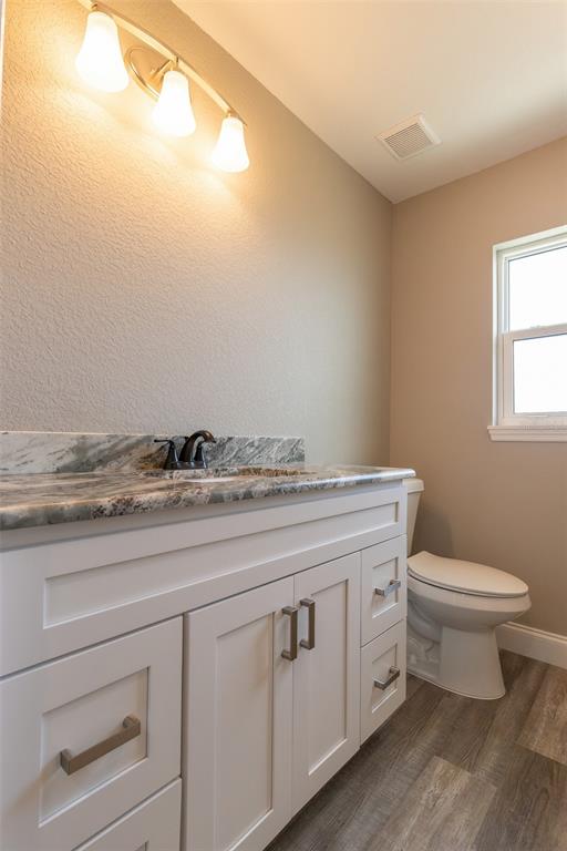 1877 Arbuckle Creek Road Sebring, FL 33870 - Photo 33 of 50 a bathroom with a granite countertop toilet and mirror