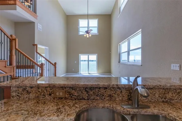 a view of a livingroom with furniture and stairs