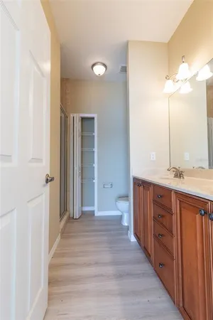 a bathroom with a granite countertop sink and a large mirror