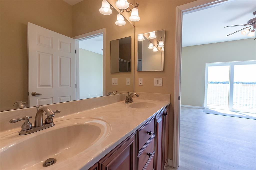 1877 Arbuckle Creek Road Sebring, FL 33870 - Photo 46 of 50 a bathroom with a granite countertop sink and a large mirror