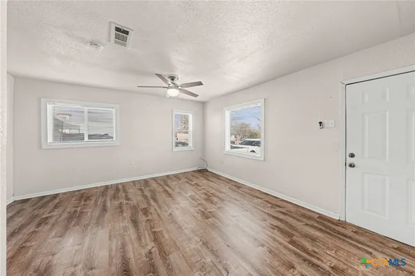 a kitchen with a sink and a refrigerator