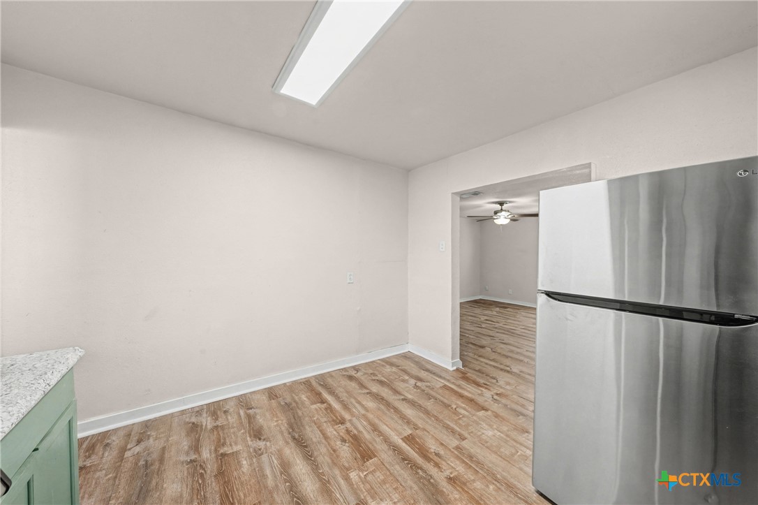 906 South 2nd Street Temple, TX 76504 - Photo 15 of 41 a view of a refrigerator in kitchen and an empty room