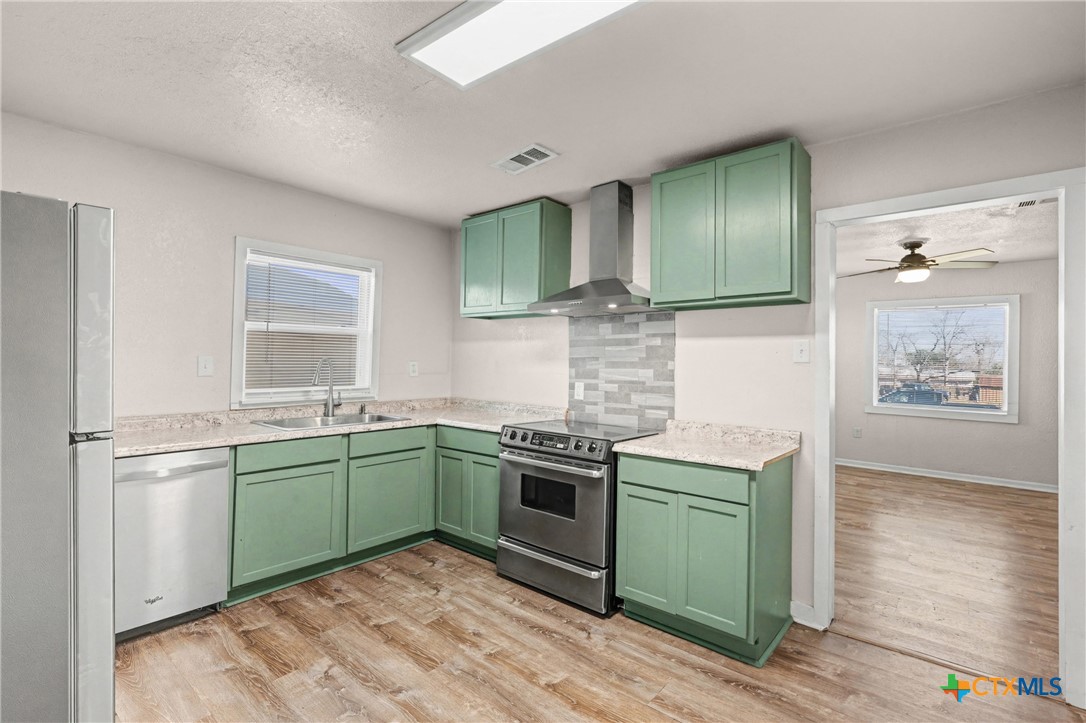 906 South 2nd Street Temple, TX 76504 - Photo 16 of 41 a kitchen with a sink and a stove top oven