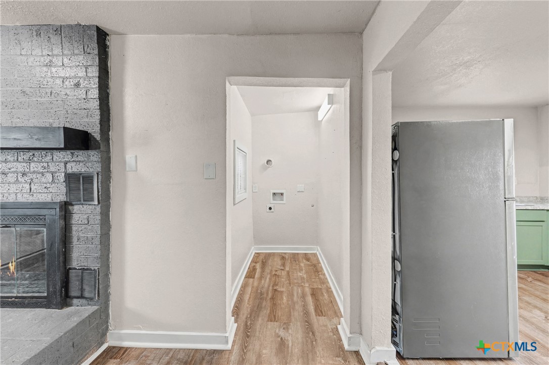 906 South 2nd Street Temple, TX 76504 - Photo 20 of 41 a view of a hallway with wooden floor and a fireplace