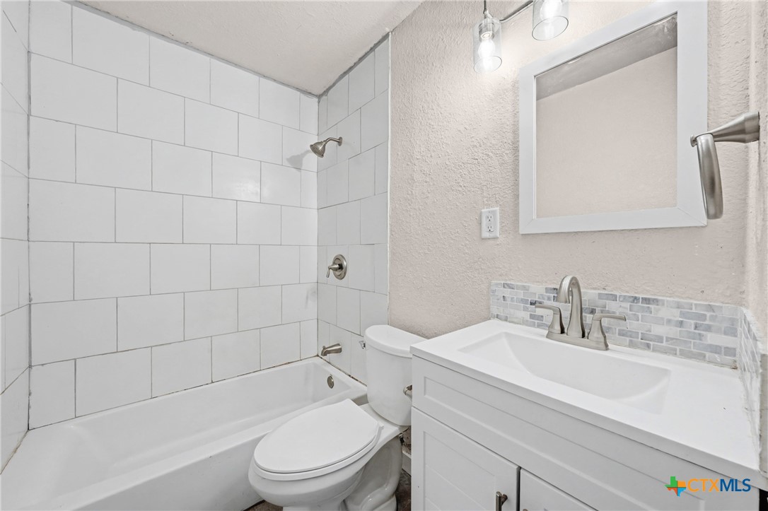 906 South 2nd Street Temple, TX 76504 - Photo 25 of 41 a bathroom with a sink a toilet and shower