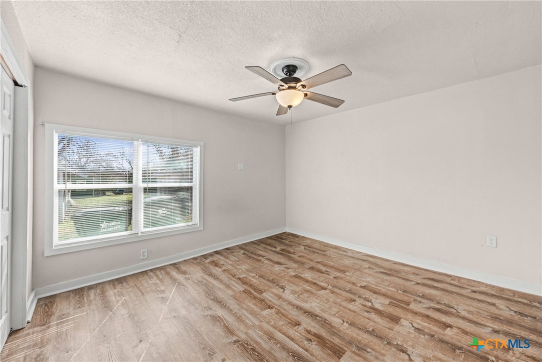 906 South 2nd Street Temple, TX 76504 - Photo 30 of 41 a view of empty room with wooden floor and fan