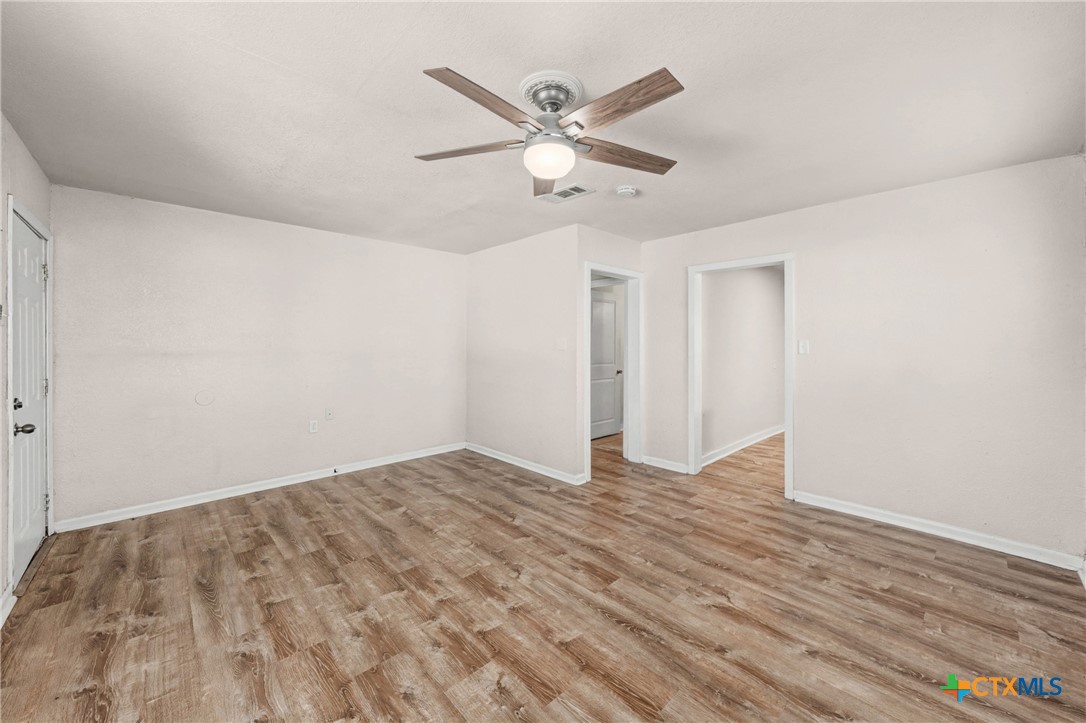906 South 2nd Street Temple, TX 76504 - Photo 8 of 41 a view of an empty room with wooden floor