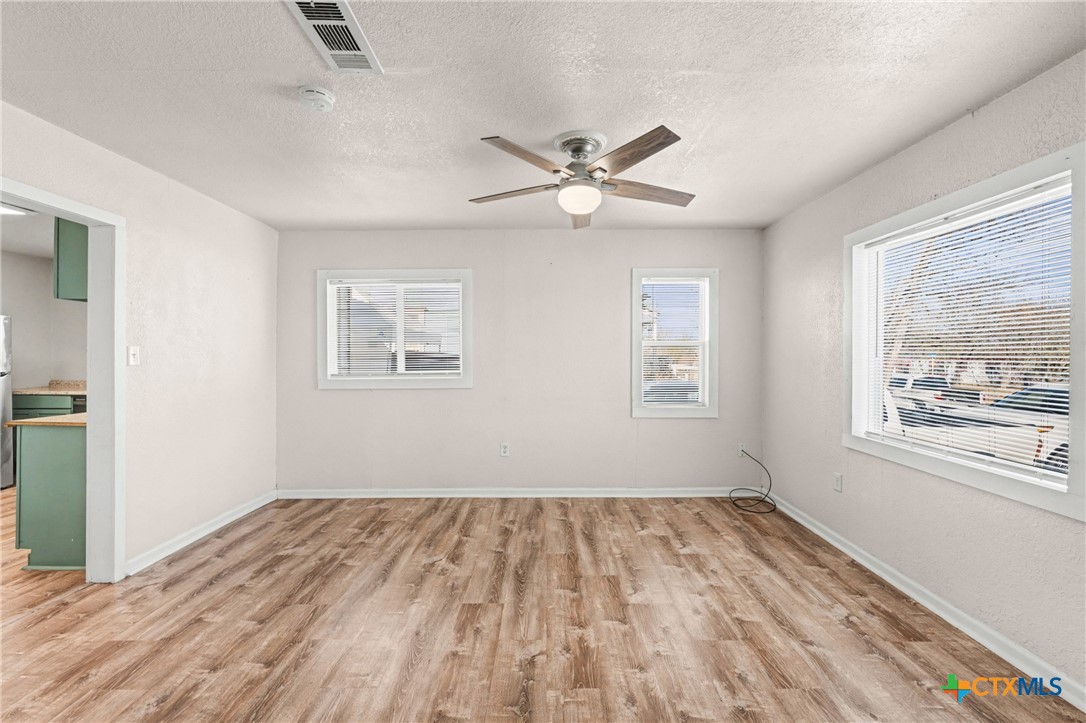 906 South 2nd Street Temple, TX 76504 - Photo 10 of 41 a view of empty room with wooden floor and fan