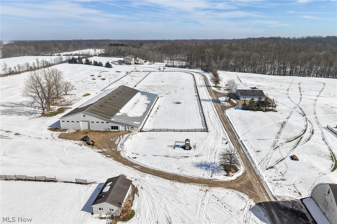 9455 Robinson Road Chardon, OH 44024 - Photo 10 of 33 Snowy aerial view featuring a wooded view