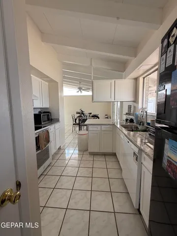 a kitchen with a sink a counter top space cabinets and stainless steel appliances