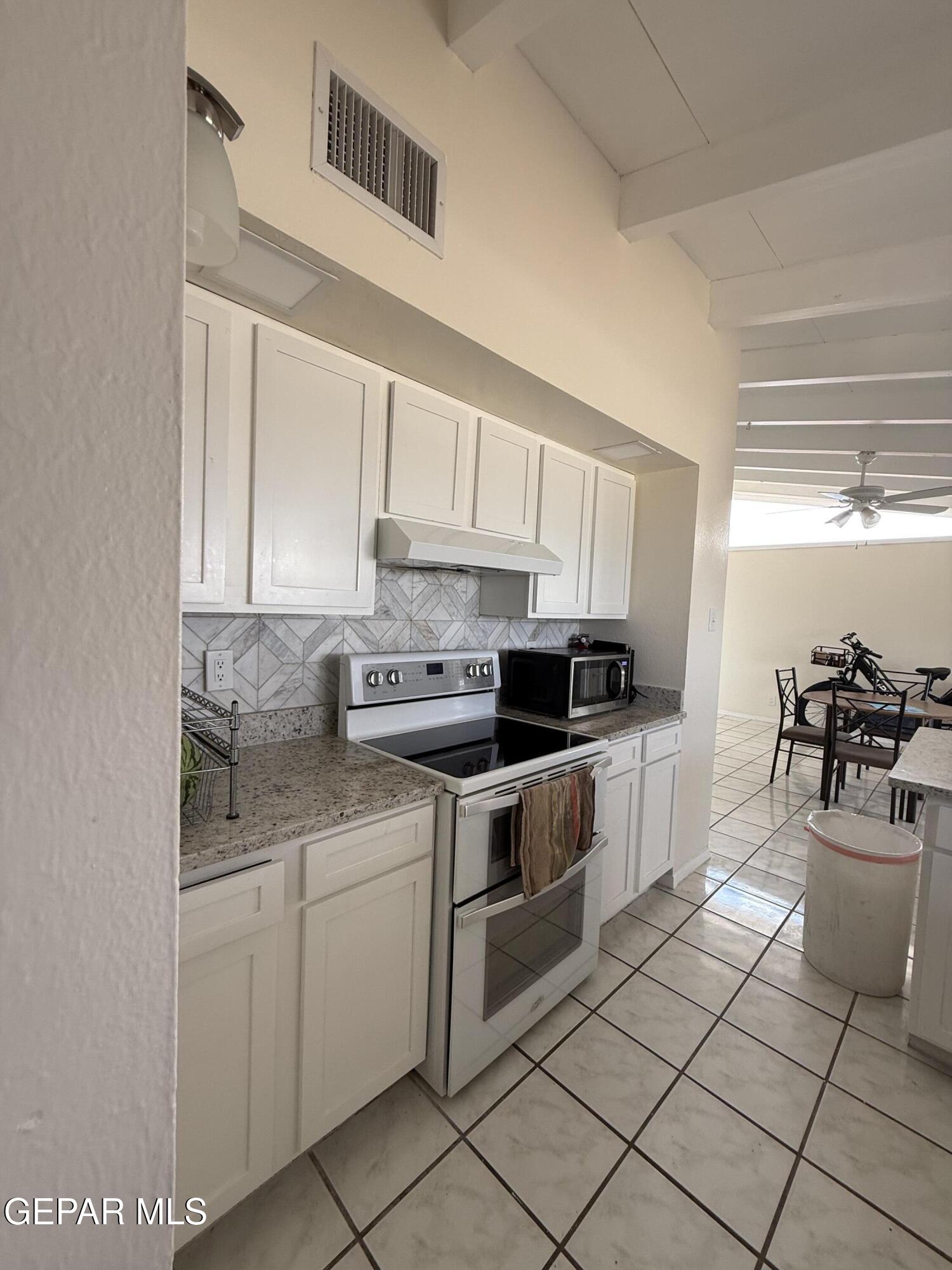 313 Clairemont Road El Paso, TX 79912 - Photo 21 of 34 a kitchen with a sink cabinets and window