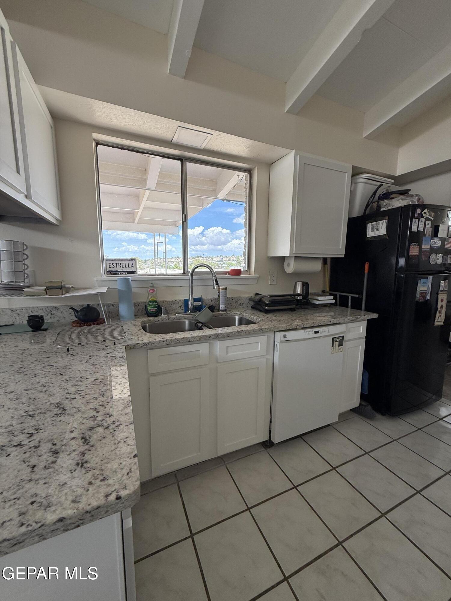 313 Clairemont Road El Paso, TX 79912 - Photo 23 of 34 a kitchen with a sink a stove a counter top space and cabinets