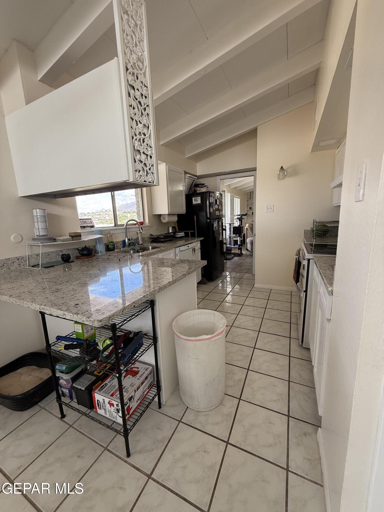 313 Clairemont Road El Paso, TX 79912 - Photo 26 of 34 a kitchen with a sink and a stove top oven