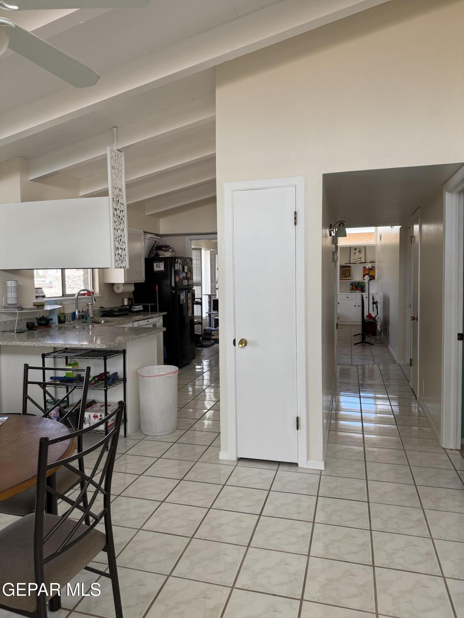 313 Clairemont Road El Paso, TX 79912 - Photo 27 of 34 a kitchen with stainless steel appliances kitchen island granite countertop a table and chairs in it