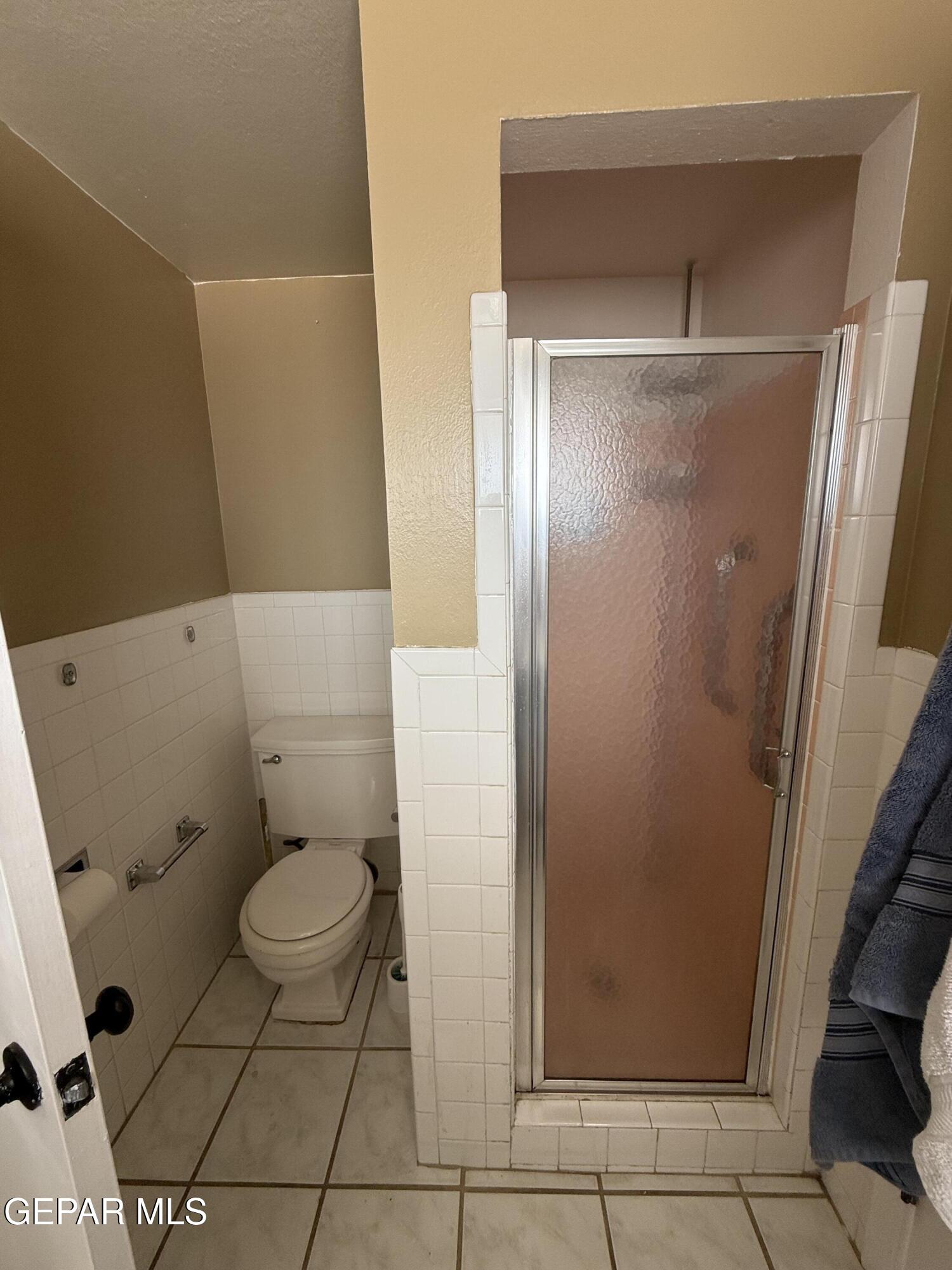 313 Clairemont Road El Paso, TX 79912 - Photo 32 of 34 a bathroom with a toilet and a shower