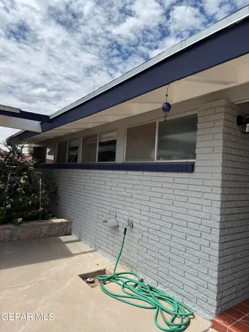 a backyard of a house with table and chairs